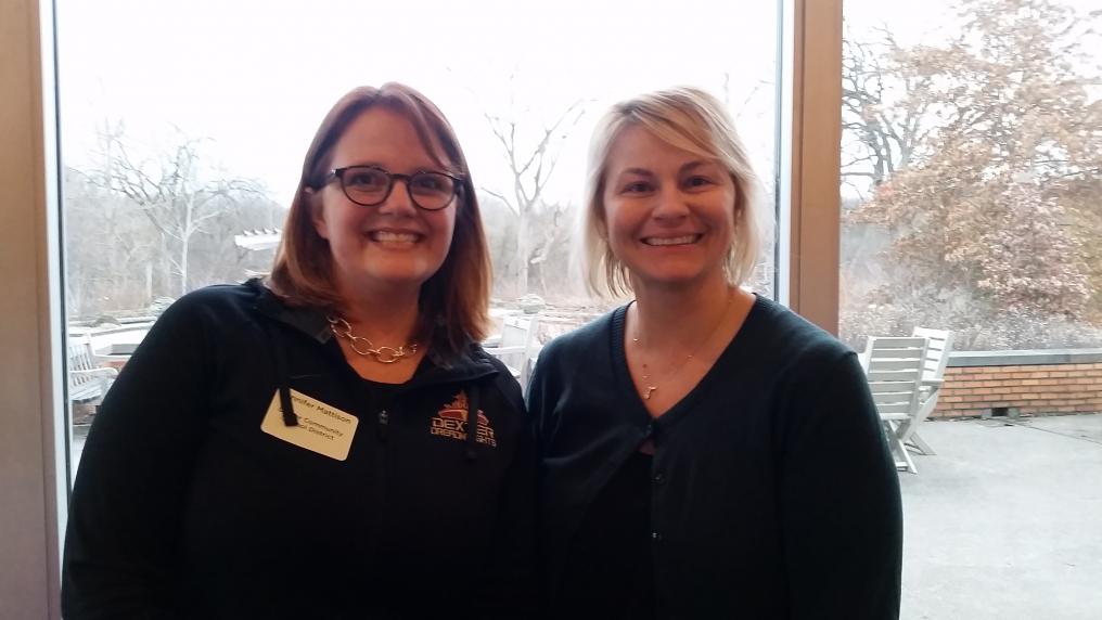 Two white women stand next to each other and smile